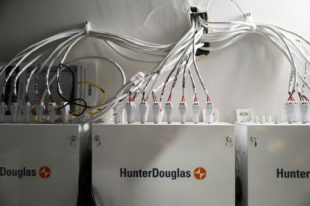 Labeled shade wires connect to three wall-mounted Hunter Douglas power supplies.